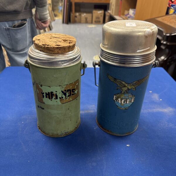 Pair of vintage metal thermos flasks, blue and green.