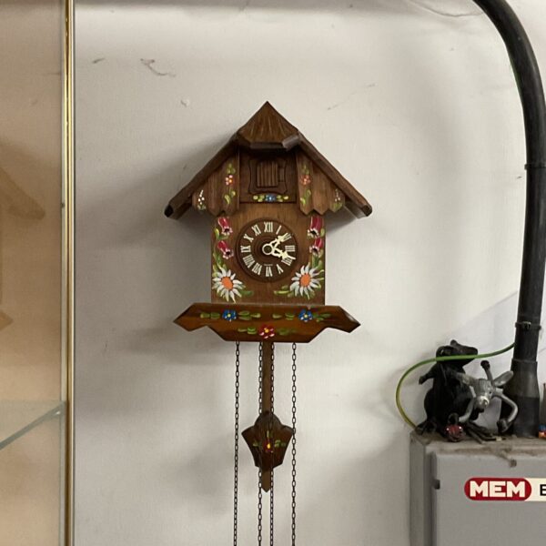 Vintage West German cuckoo clock with floral details.