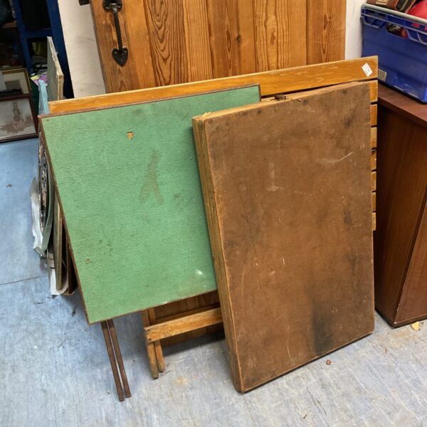 Vintage wooden folding card table with green painted surface.