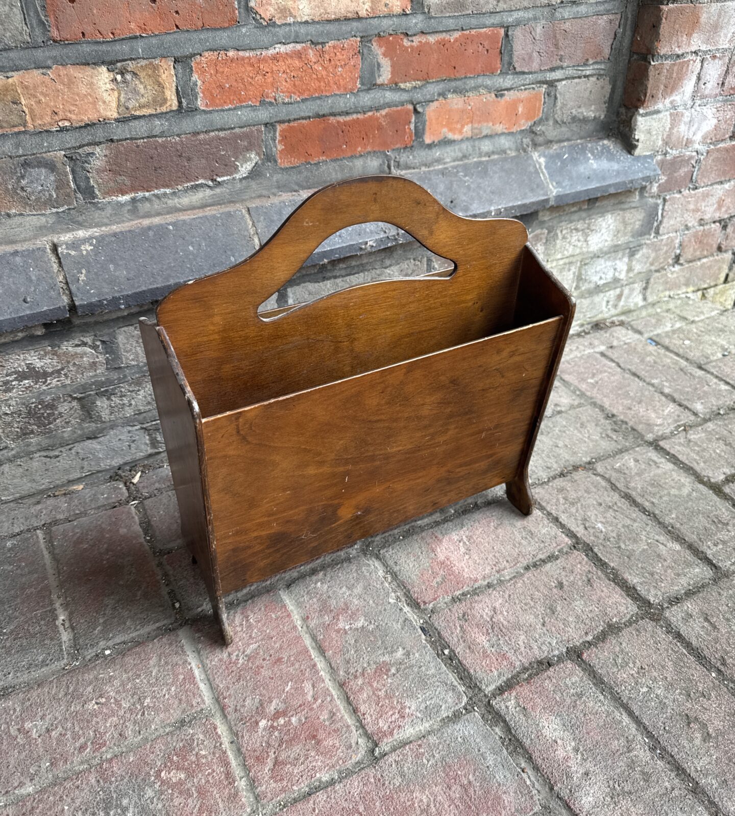 Vintage wooden magazine rack for books and periodicals.