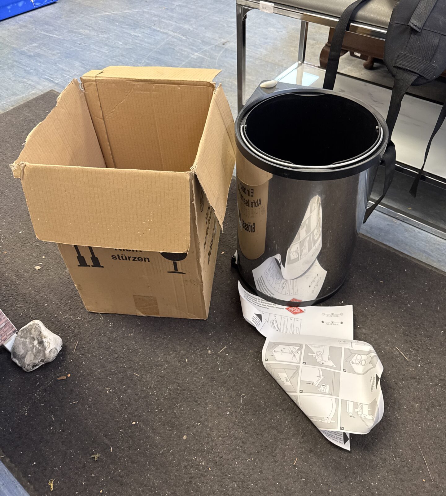 Wesco built-in waste bin with cardboard box nearby.