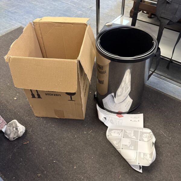Wesco built-in waste bin with cardboard box nearby.