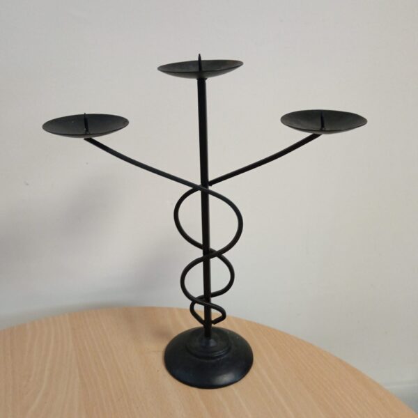 Vintage wrought iron candelabra with three arms for candles.
