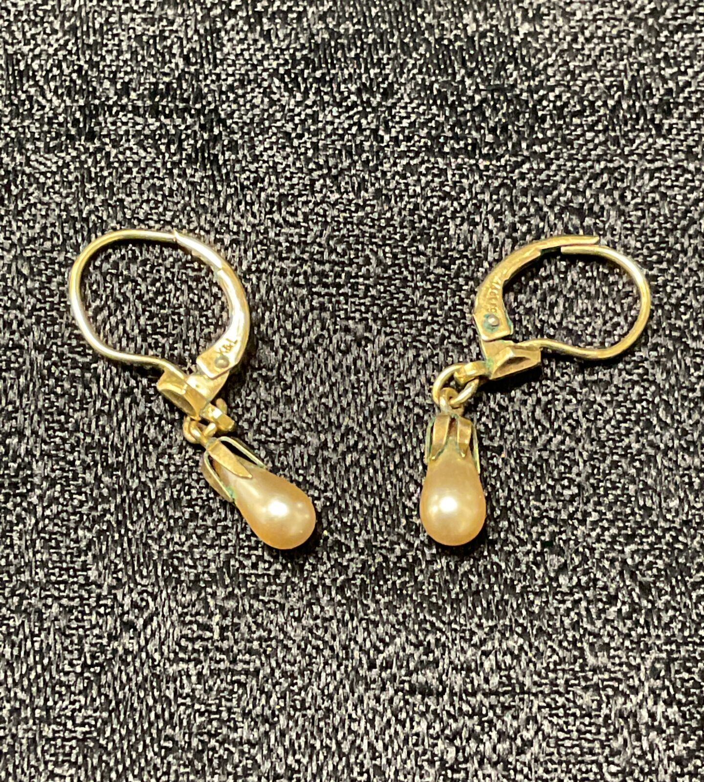 Classic 14ct gold pearl earrings with a lustrous sheen.