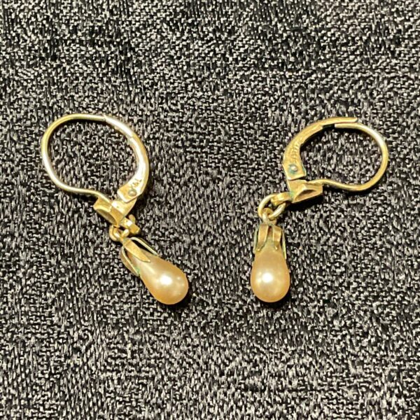 Classic 14ct gold pearl earrings with a lustrous sheen.