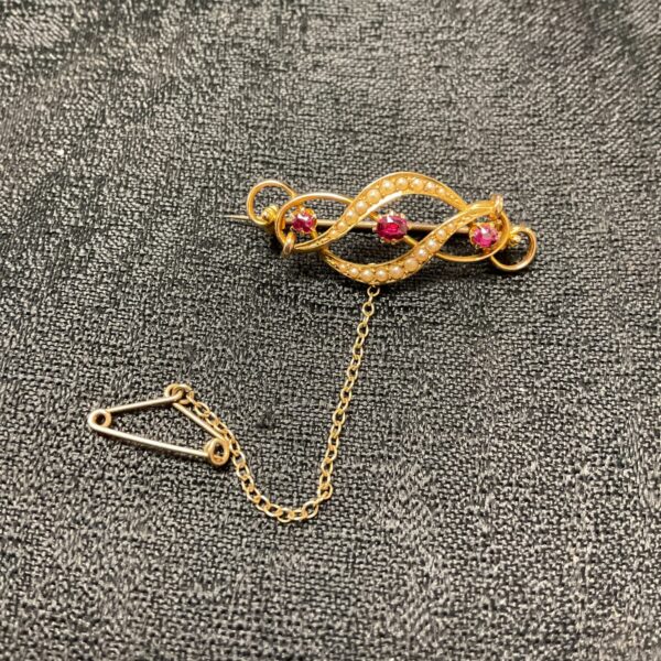 Antique 15 carat gold brooch with ruby and pearl detailing.
