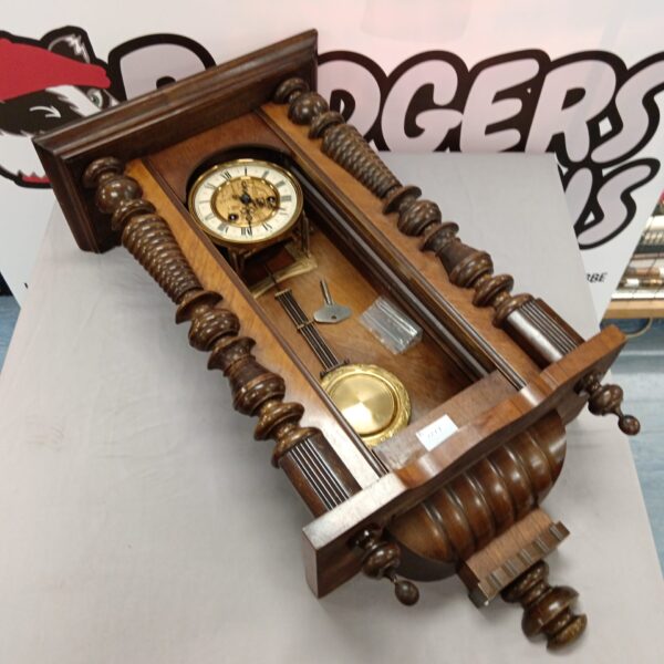 Antique mechanical wall clock with Roman numeral face for restoration.