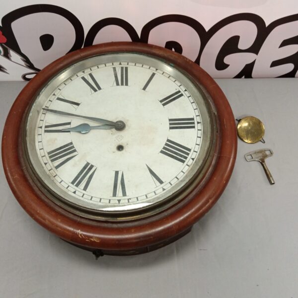 Antique Ansonia wall clock with Roman numerals and pendulum.