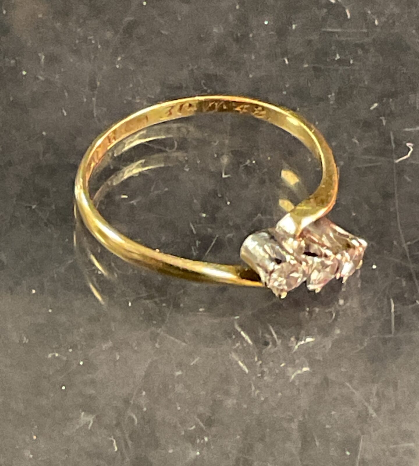 Vintage 18ct gold trilogy diamond ring, close-up view.