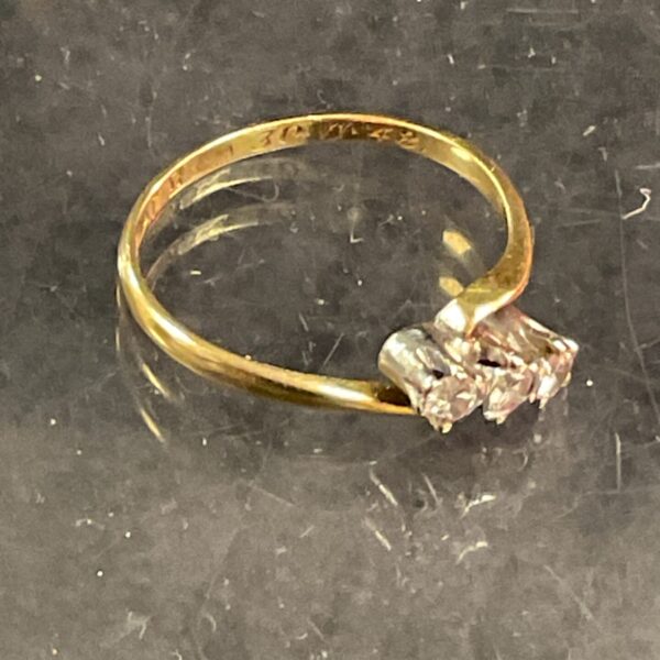 Vintage 18ct gold trilogy diamond ring, close-up view.