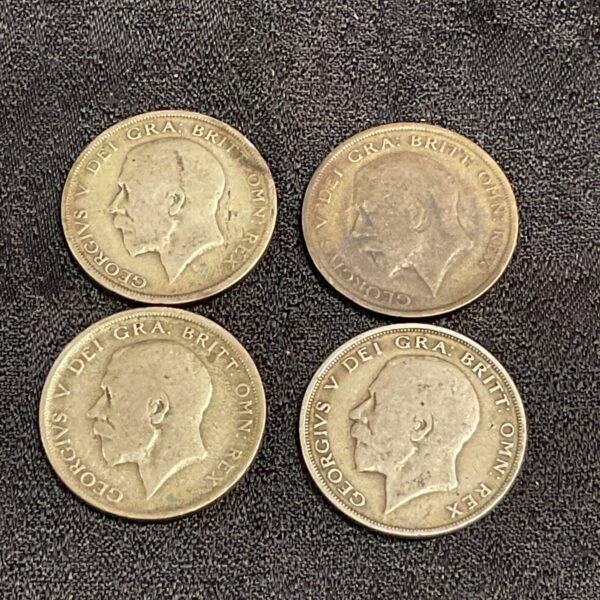 Four 1920 half crown coins showing King George V portrait.