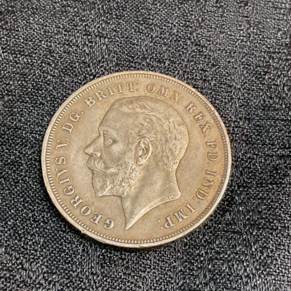 1935 Silver Crown coin featuring King George V portrait.
