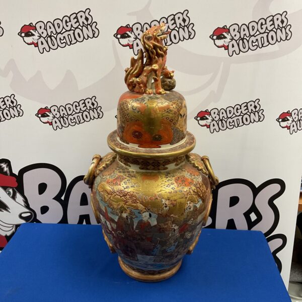Antique 19th-century temple vase with dragon finial, detailed porcelain.