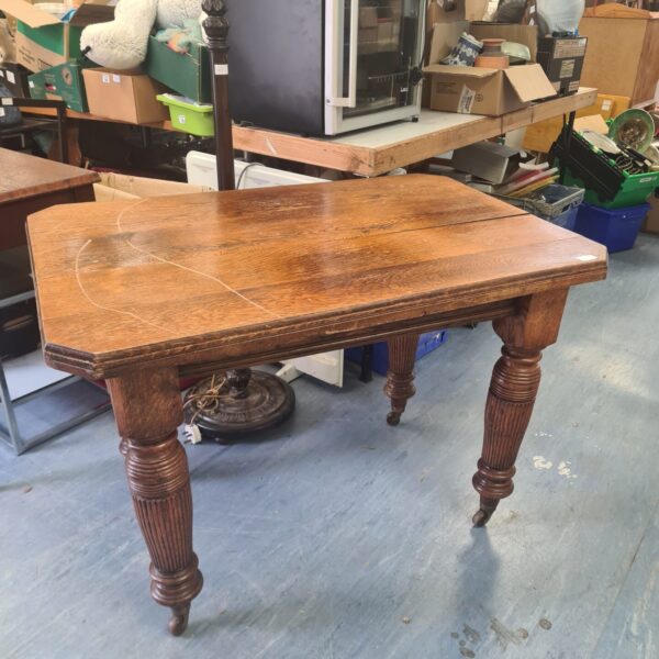Victorian oak kitchen table with ceramic casters, antique farmhouse style.