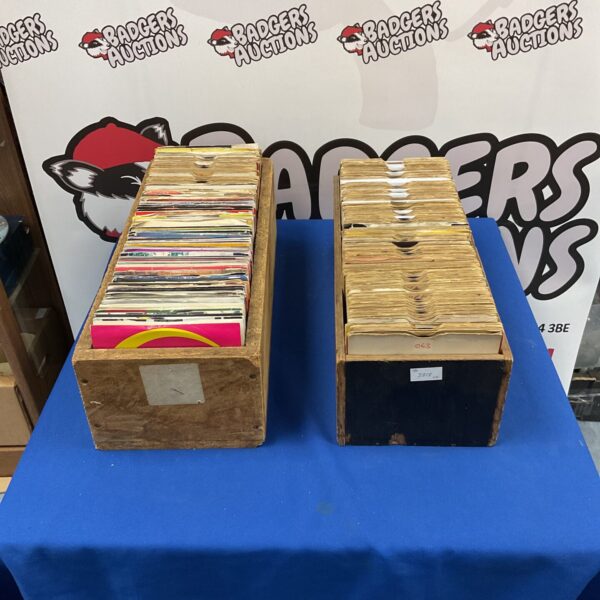 Vintage 7 inch vinyl records in wooden boxes, a collectible music lot.