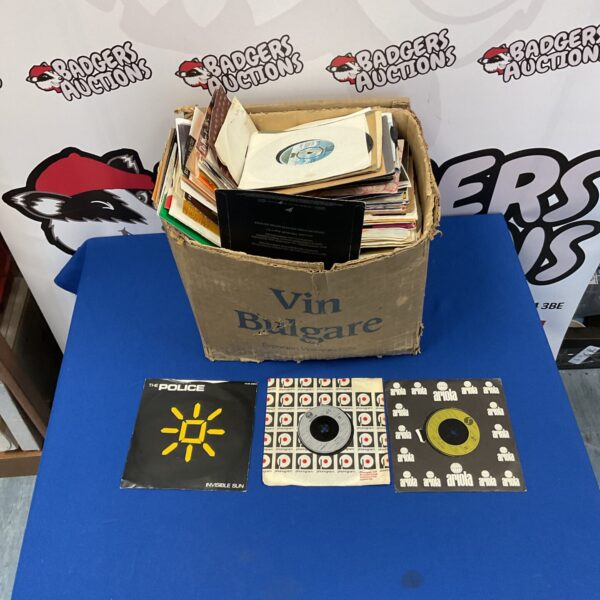 Box of vintage 7 inch vinyl singles for collectors.