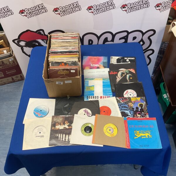 Collection of 7 inch vinyl singles including punk, reggae, and new wave records.