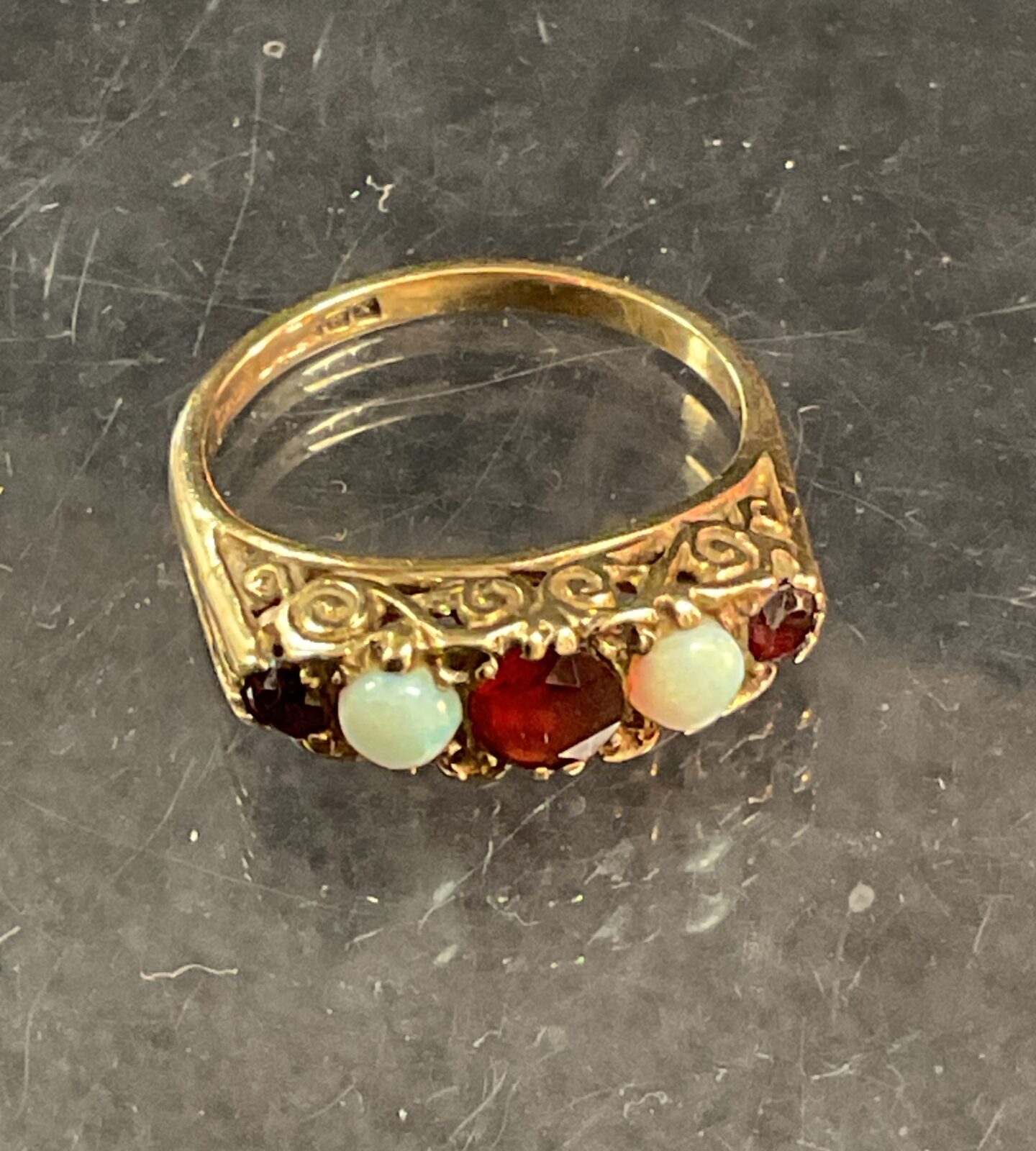 Close-up of a vintage 9 carat garnet and fire apple ring.