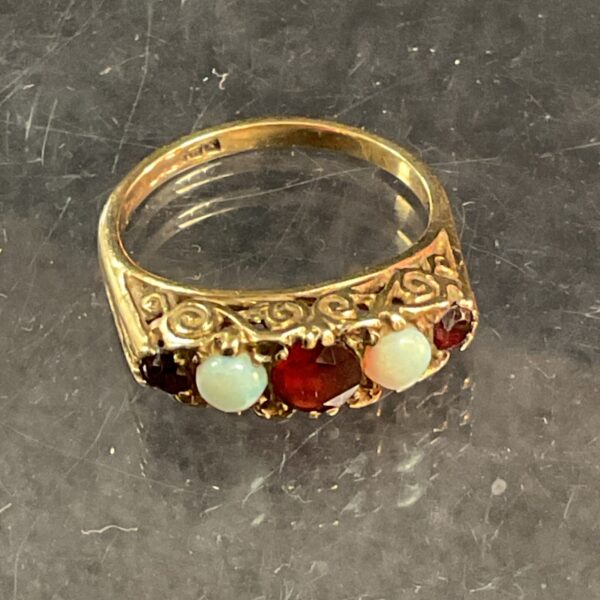 Close-up of a vintage 9 carat garnet and fire apple ring.