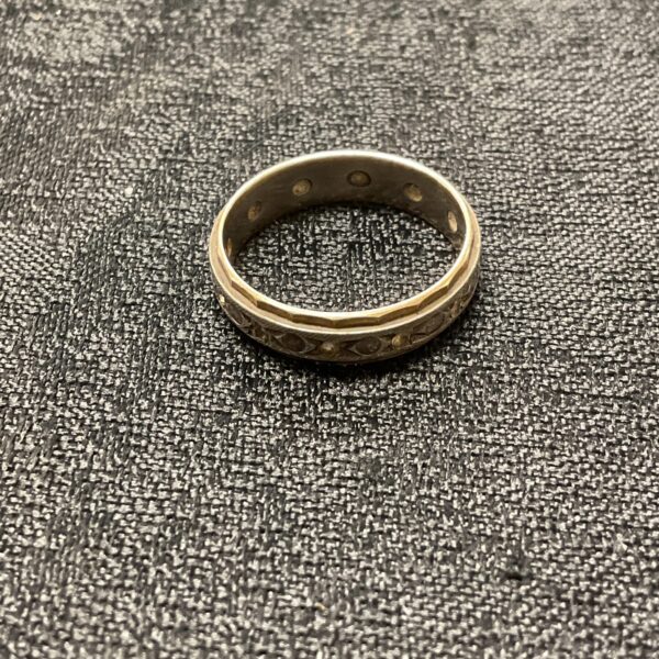 Close-up of a 9 carat gold ring with a two-tone band.