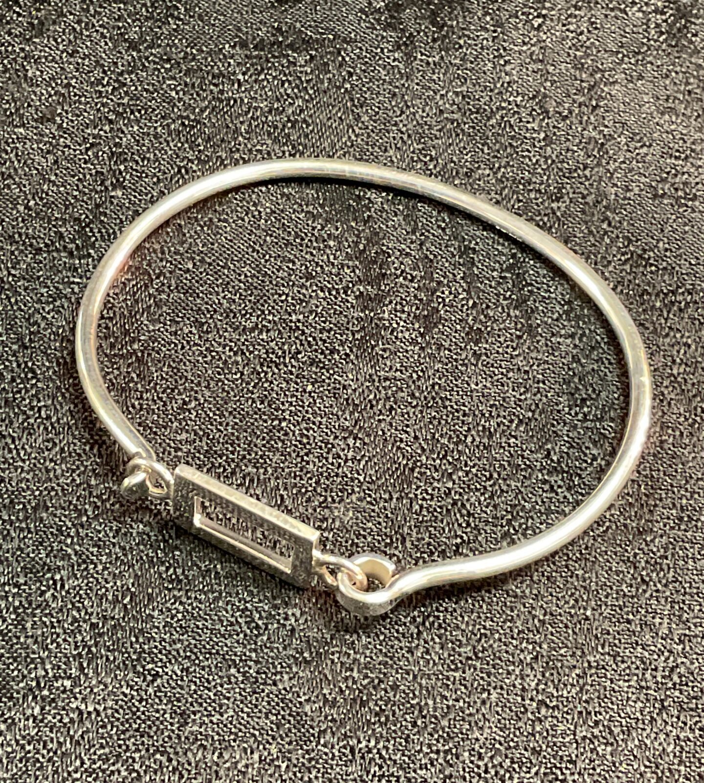 Delicate 925 silver bangle bracelet, minimalist design.
