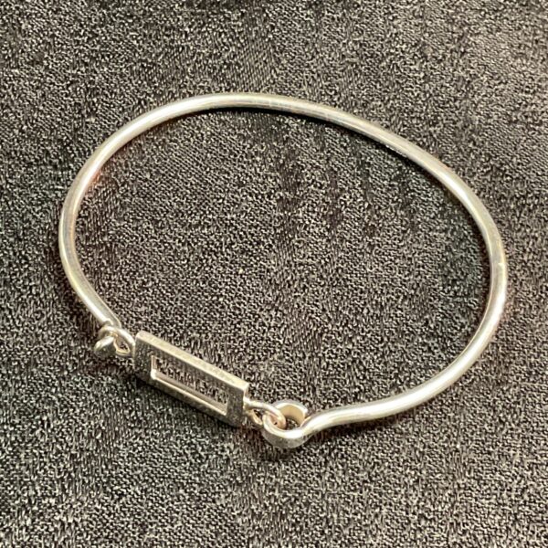 Delicate 925 silver bangle bracelet, minimalist design.