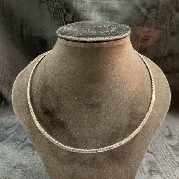 Delicate 925 silver choker necklace on a display stand.