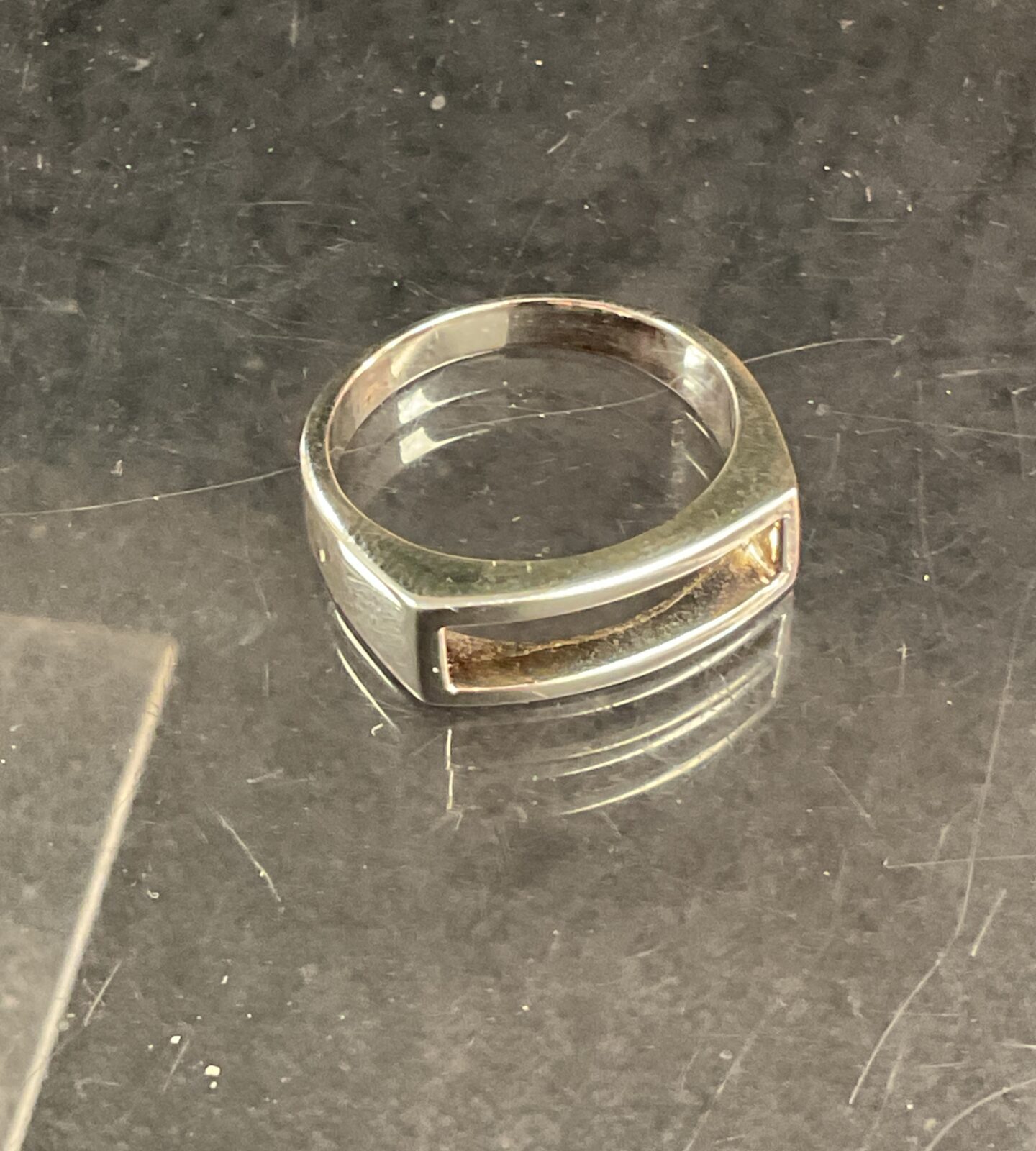 Close-up of a 925 silver ring with a textured band.