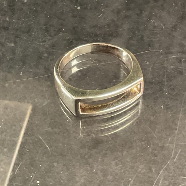 Close-up of a 925 silver ring with a textured band.