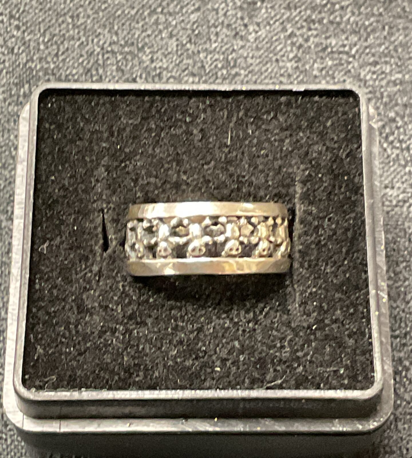 Close-up of a 925 silver textured band ring.