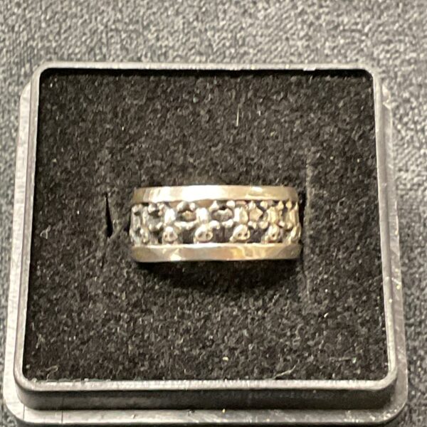 Close-up of a 925 silver textured band ring.