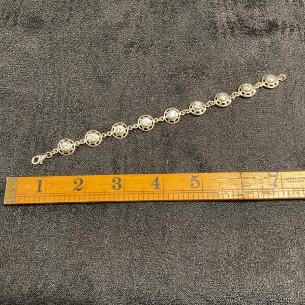 Close-up of a 925 silver bracelet with white stones.