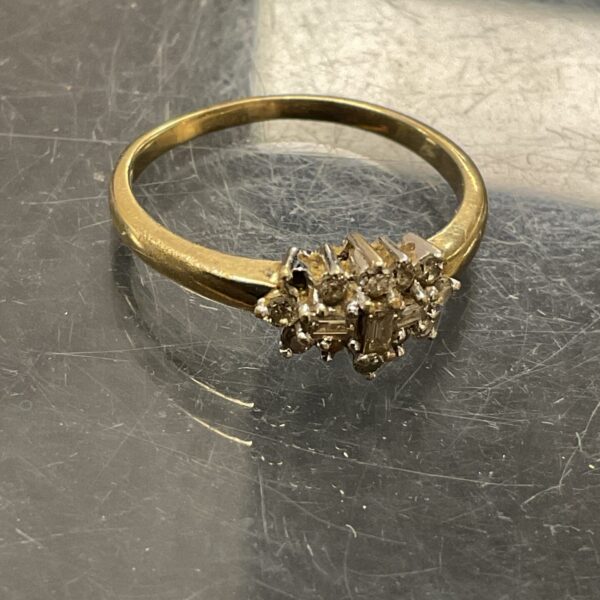 Close-up of a 9ct gold diamond cluster ring, size Q.