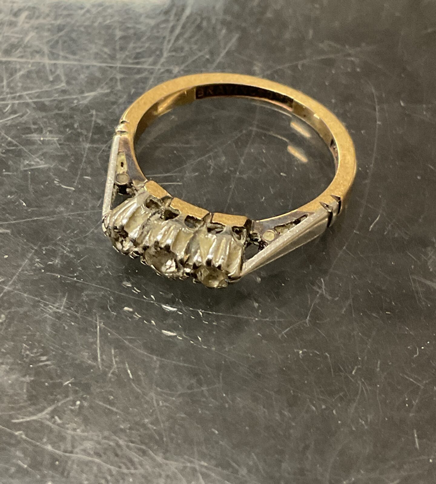 Close-up of a 9ct gold diamond ring with platinum band.