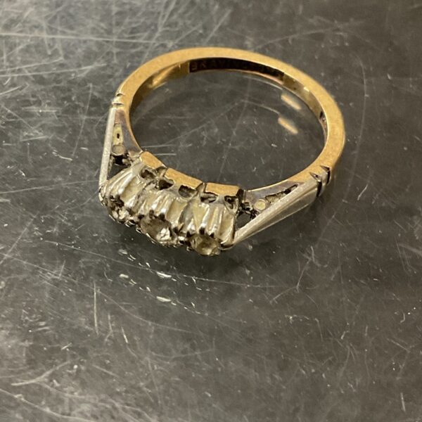 Close-up of a 9ct gold diamond ring with platinum band.