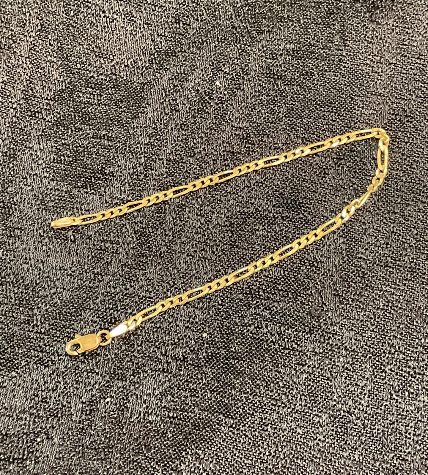 Delicate 9ct gold figaro bracelet with flat links.