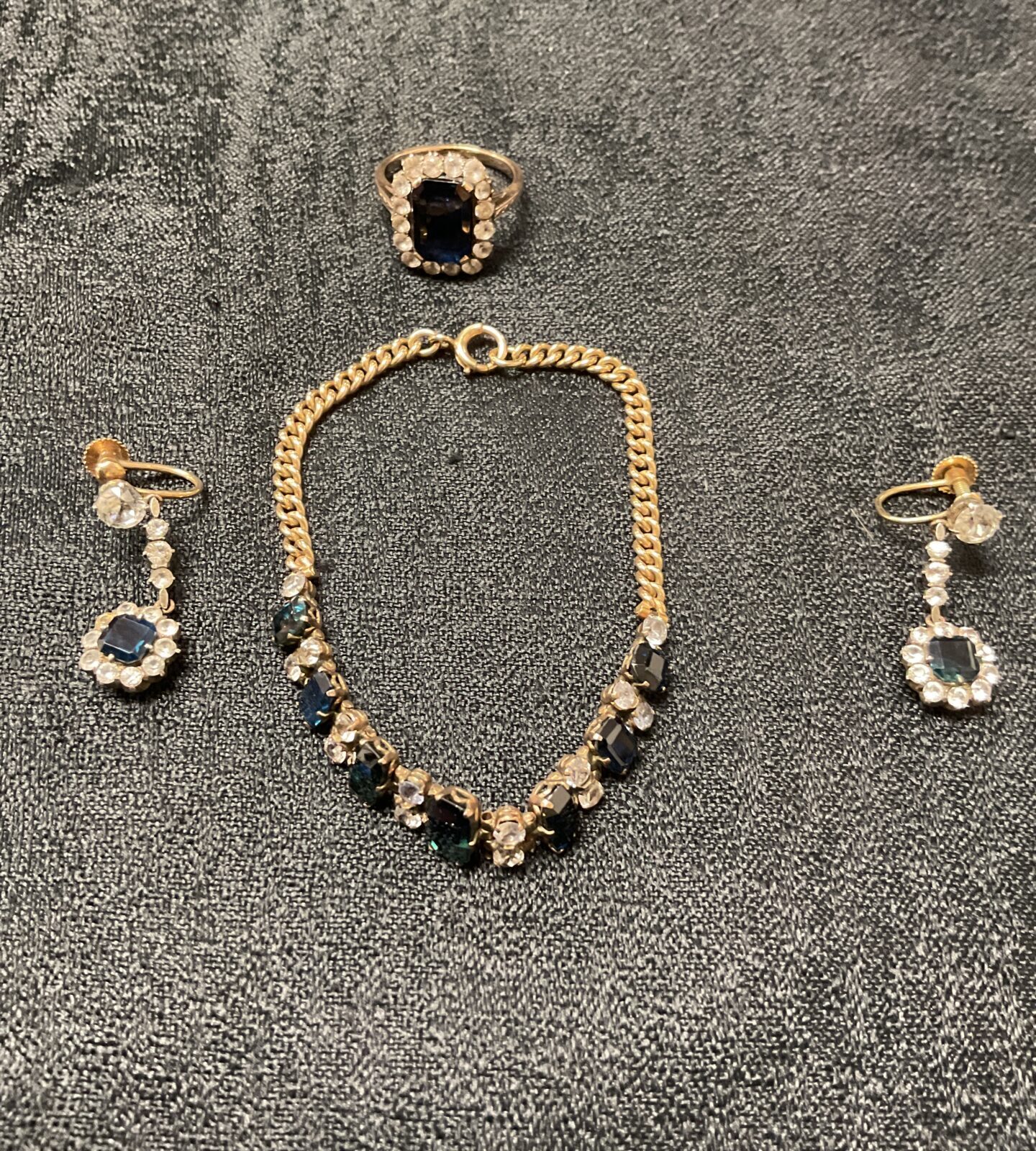 9ct gold jewellery set featuring a bracelet, ring, and earrings.