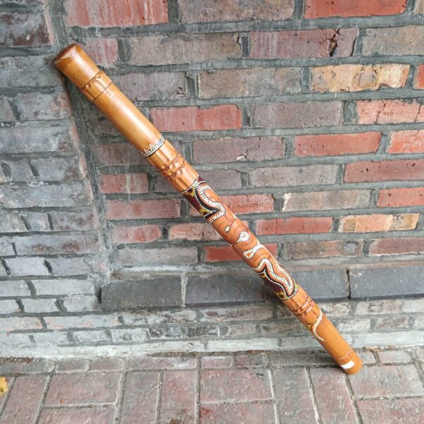 Hand-painted Aboriginal didgeridoo with traditional designs.