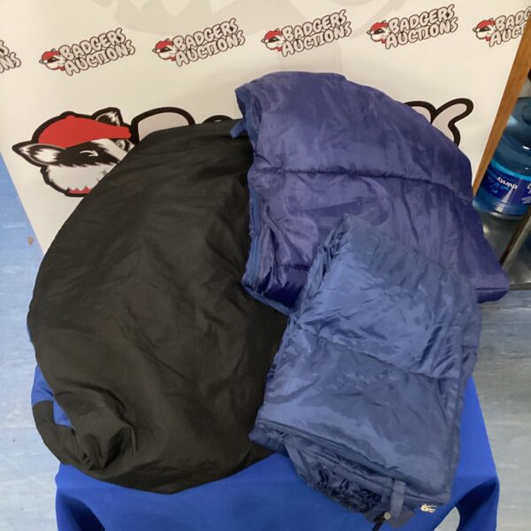 Lot of three adult sleeping bags for camping and travel.