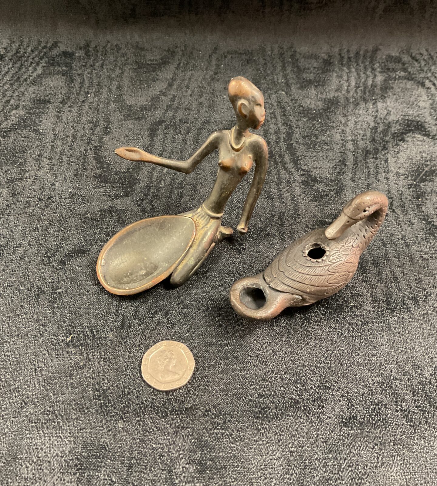 Antique African bronze figure and oil lamp, collectible tribal art.