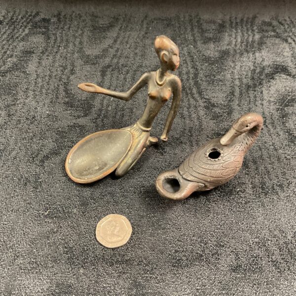 Antique African bronze figure and oil lamp, collectible tribal art.