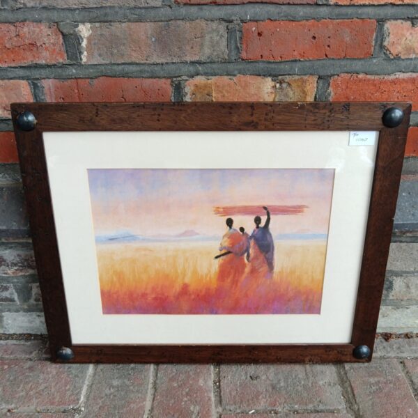 Framed print of African farmers in a golden field landscape.