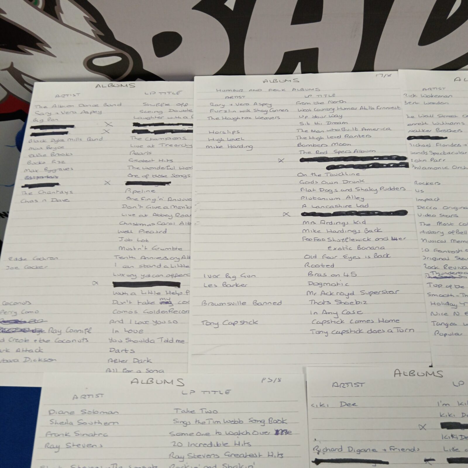 Handwritten list of album titles and artists, page one.