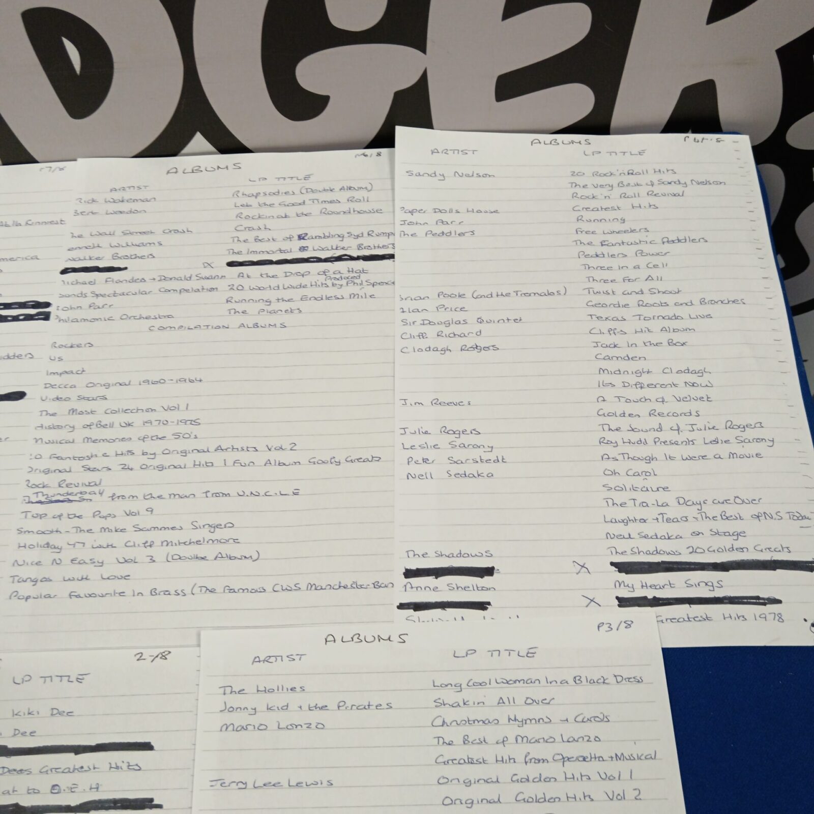 Handwritten list of album titles and artists, page two.