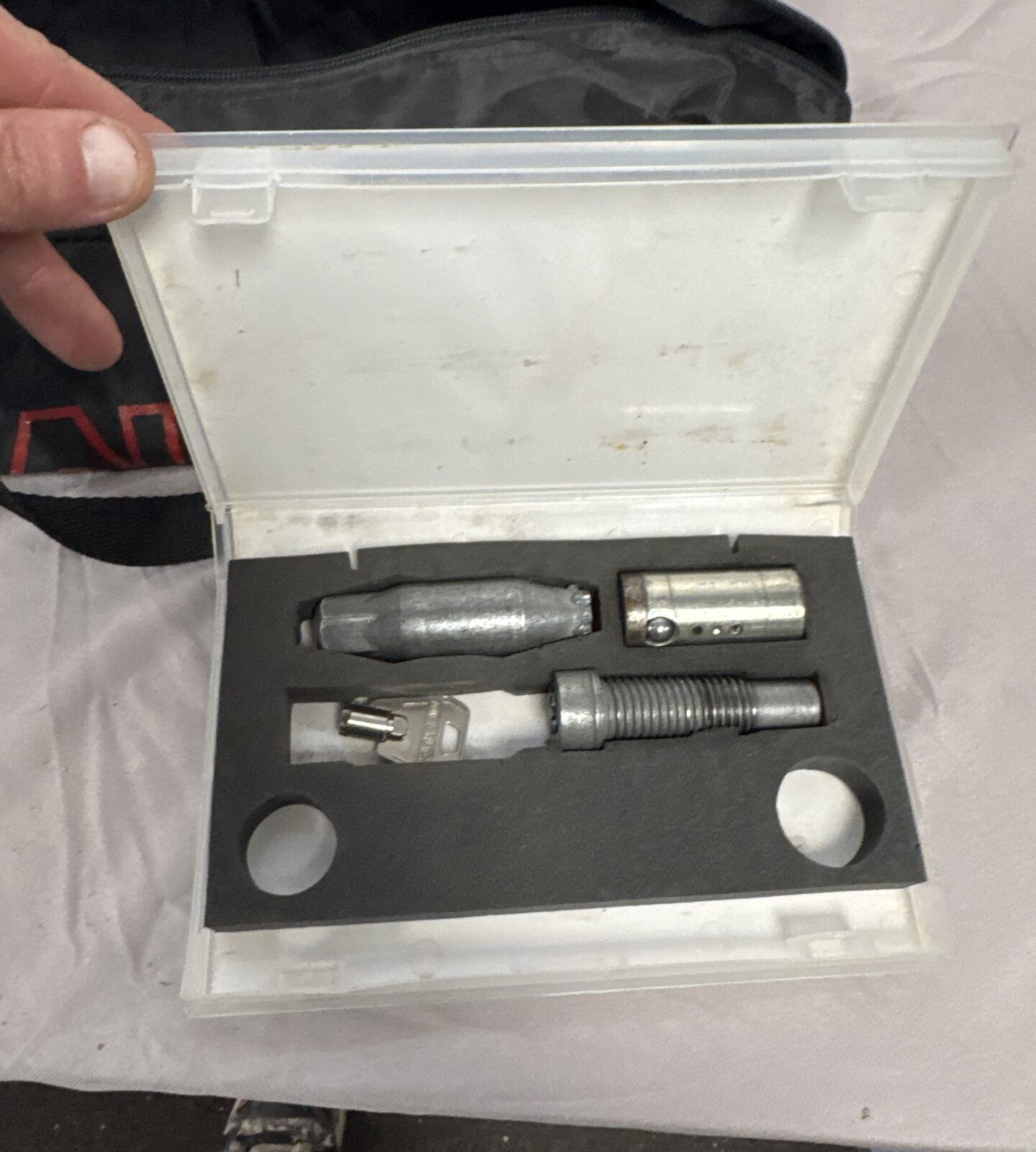 Close-up of Al-ko wheel lock kit components and keys.