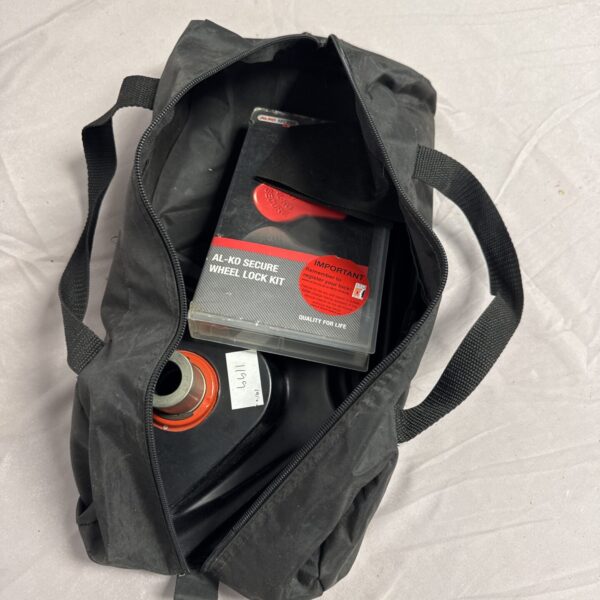 Open black bag showing Al-ko wheel lock kit components.