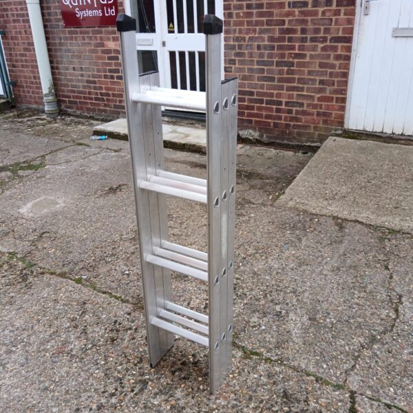 Silver aluminium loft ladder leaning against a wall.