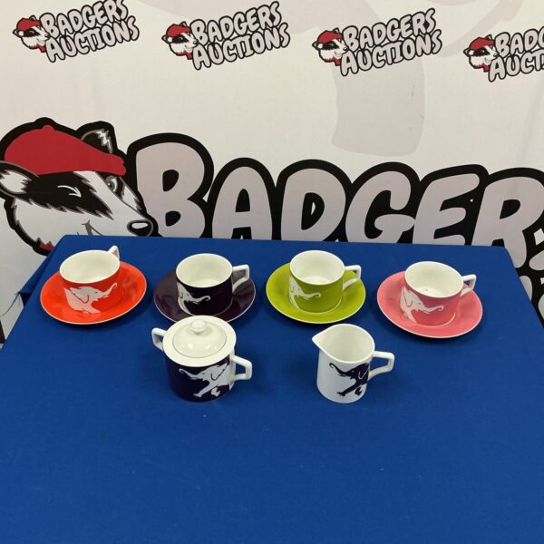Vibrant Andrew Martin coffee set with patterned cups and saucers.