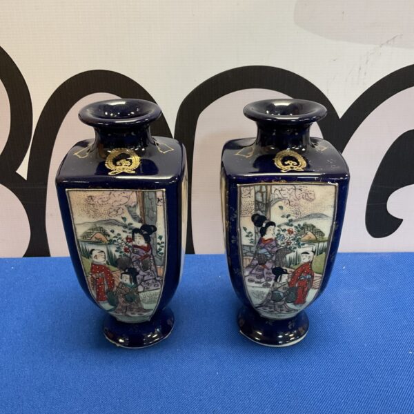 Pair of antique Chinese porcelain vases with detailed artwork.