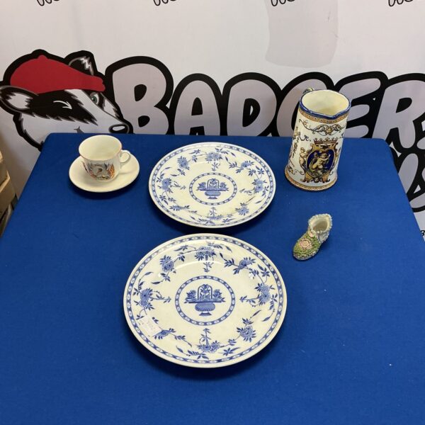 Antique Delft plates with delicate floral designs, vintage Dutch ceramics.